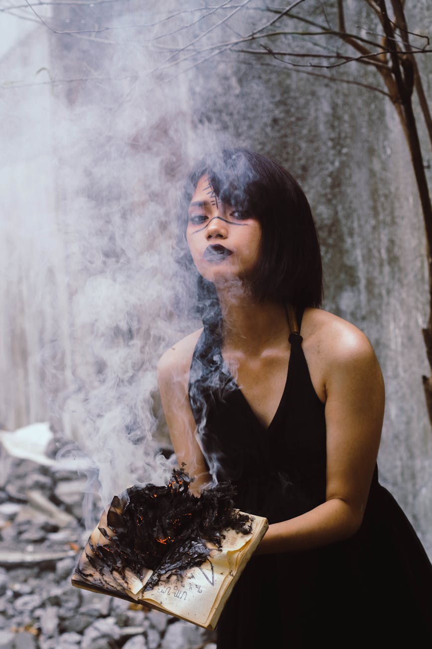 woman holding book on fire
