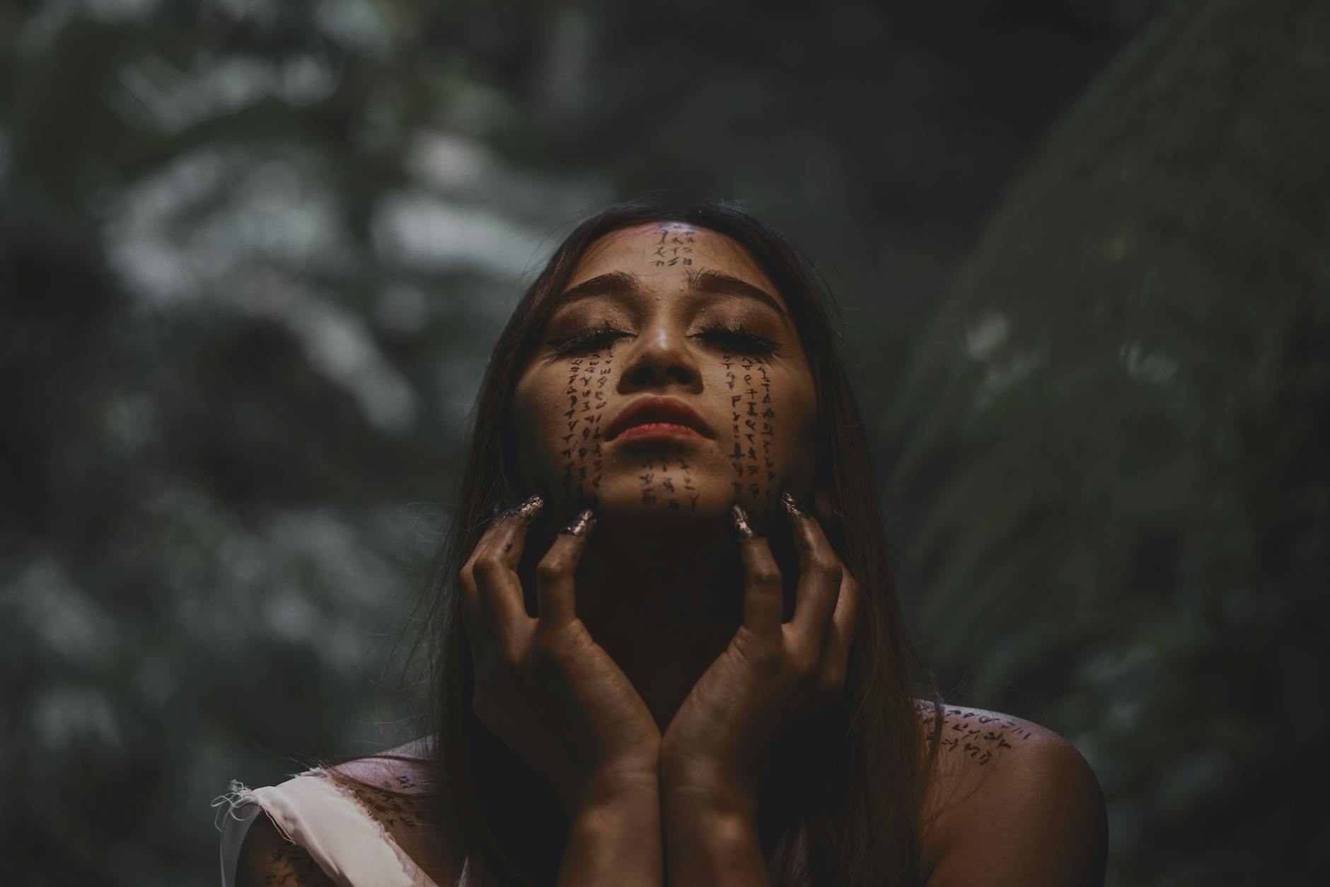 shallow focus photo of woman with face art