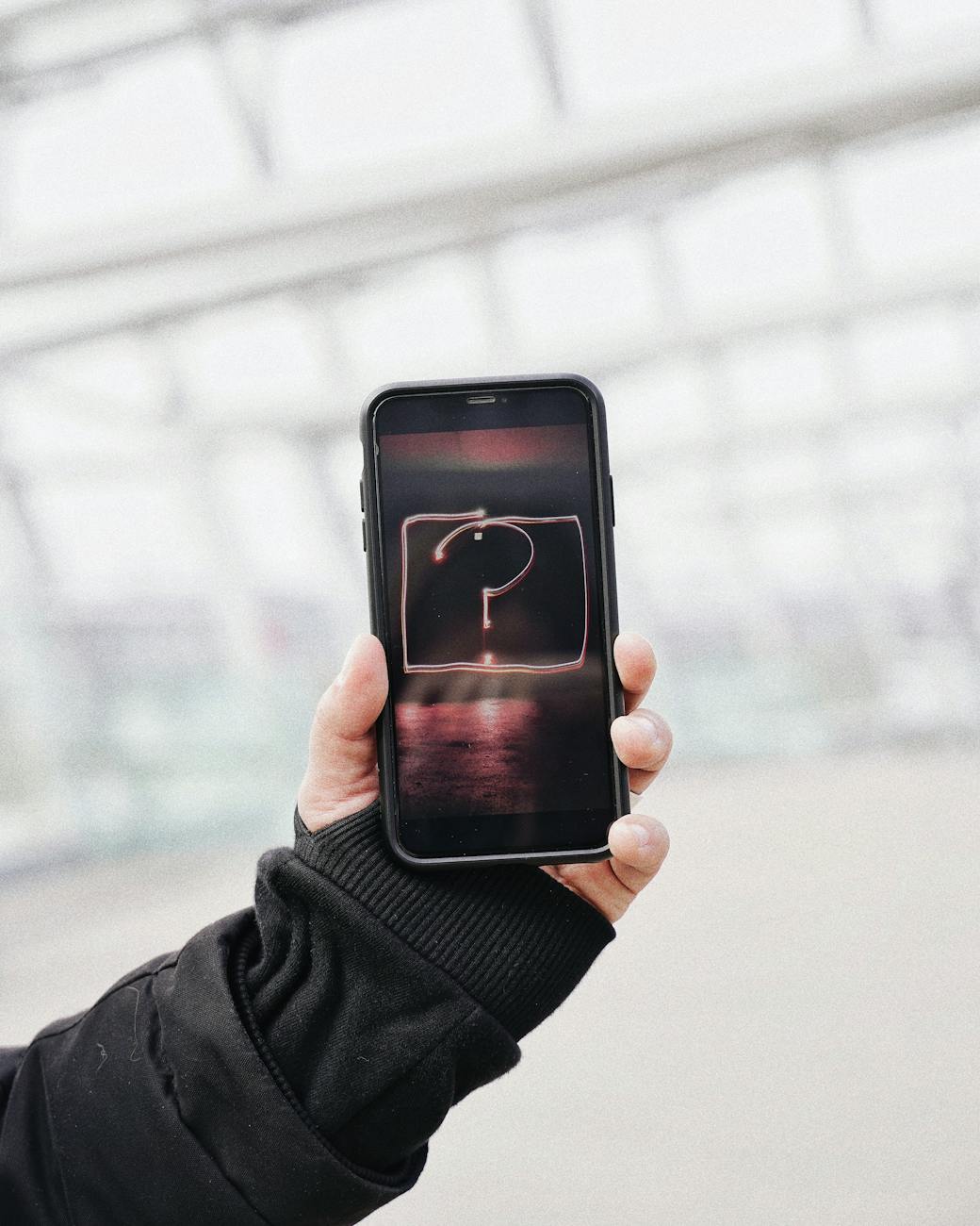person holding black iphone